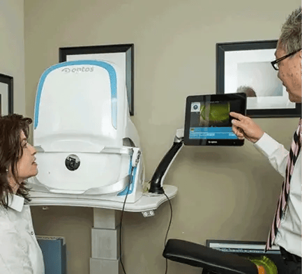 Retina specialist reviewing macular degeneration imaging at New England Retina Associates
